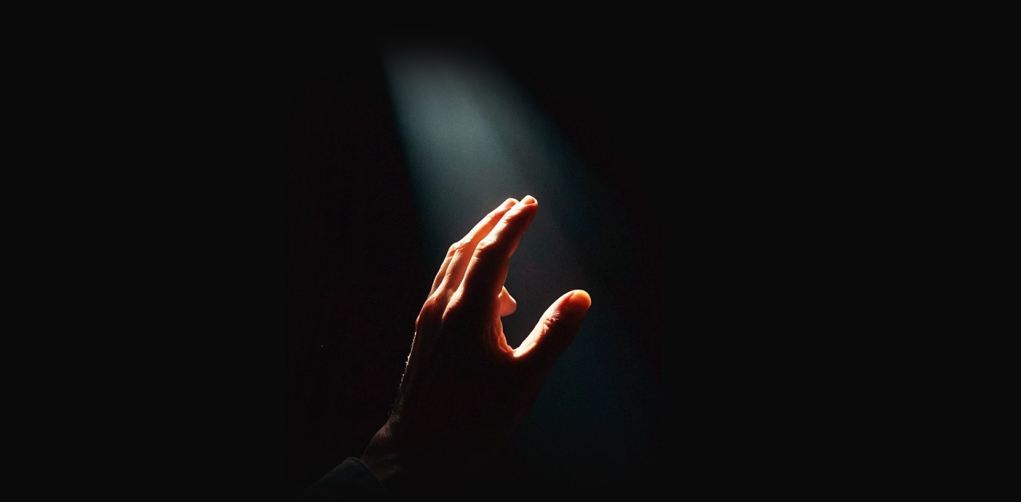 person hand in a dramatic lighting